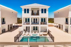 an aerial view of a house with a swimming pool at Miramare - Beachfront Luxury with Pool & Elevator in Orange Beach