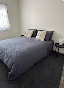 a bedroom with a large bed with pillows on it at Dylans Accommodation Sea Lake in Sea Lake