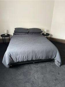 a bedroom with a bed with two nightstands and two lamps at Dylans Accommodation Sea Lake in Sea Lake