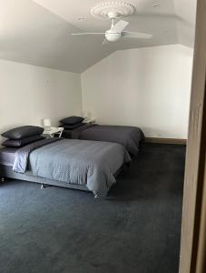 a bedroom with two beds and a ceiling fan at Dylans Accommodation Sea Lake in Sea Lake