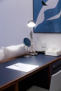 a desk with a lamp on top of it at Small House Big Door Myeongdong in Seoul