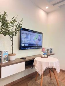 a living room with a tv on a wall at GreenBay- G34030 in Hanoi +7 photos