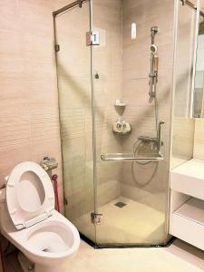 a bathroom with a toilet and a glass shower at GreenBay- G34030 in Hanoi