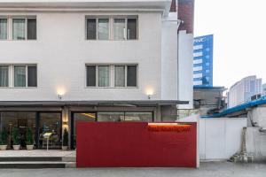 a building with a red wall in front of it at Small House Big Door Myeongdong in Seoul