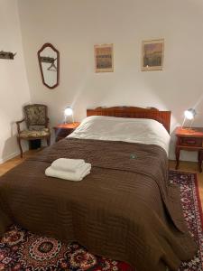 a bedroom with a large bed with two towels on it at Studija Mona in Vilnius