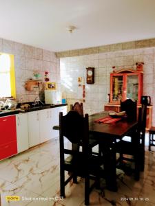 a kitchen with a table and chairs in a room at Casa Amarela-Quartos in Uberlândia +9 photos