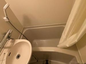 a bathroom with a toilet and a sink and a tub at Popotel 3 Shaking Secret Room in Matsumoto +17 photos