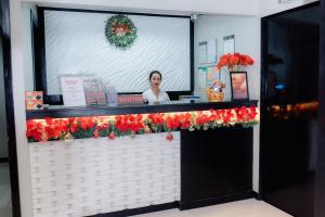 a woman behind the counter of a christmas store at Aikiko House in Davao City