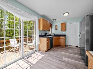 a kitchen with wooden floors and a large window at Freedom's Stay at Liberty Hills in Jacksonville
