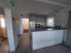 a kitchen with white cabinets and a white counter top at Paz en Funes in Funes
