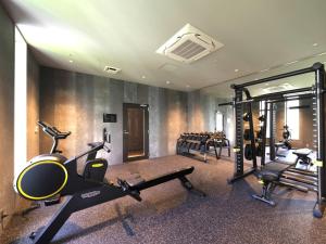 a gym with several treadmills and machines in a room at Hotel Oriental Express Fukuoka Nakasu Kawabata in Fukuoka