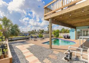 a backyard with a swimming pool and a wooden pergola at Waterfront hideaway on the canal in South Daytona