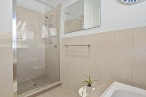 a white bathroom with a shower and a sink at Jacks Corner - 10 Marjory Street, Normanville in Normanville +22 photos