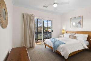 a bedroom with a bed and a large window at Jacks Corner - 10 Marjory Street, Normanville in Normanville