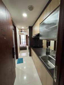 a kitchen with a sink and a counter top at Pollux habibie batam in Bagam