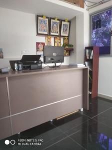 a reception desk with a computer on top of it at Royal Residency in Mahabalipuram