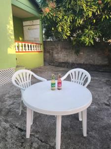 two bottles of drinks sitting on a white table at Hidden Bungalow in Roseau
