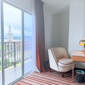 ein Zimmer mit einem Stuhl und einem Fenster mit dem Eiffelturm in der Unterkunft Goldsands Hotel Langkawi in Kuah + 19 Fotos