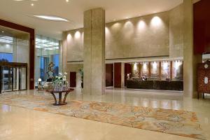 a lobby with a table in the middle of a building at Crowne Plaza Zhenjiang by IHG in Zhenjiang