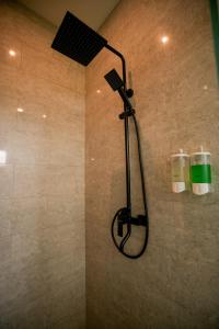 a shower with a shower head in a bathroom at Serenity Uluwatu in Uluwatu