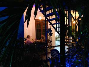 two people sitting at a table in a restaurant at night at Ella Green Breeze in Ella