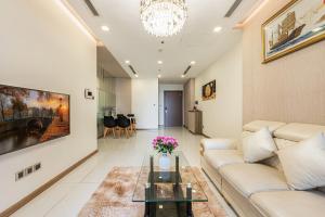 a living room with a couch and a table at Landmark Apartment City View in Kon Rung (1)