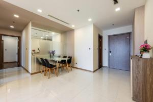 a kitchen and dining room with a table and chairs at Landmark Apartment City View in Kon Rung (1) +7 photos