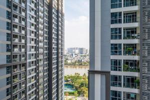 a view of a river between two tall buildings at Landmark Apartment City View in Kon Rung (1)
