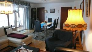 a living room with a couch and a table at Ferienwohnung Westerwaldblick Dillenburg in Dillenburg