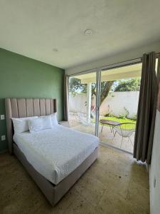 a bedroom with a bed and a patio with a table at Bosque Geométrico in Tepoztlán +88 photos