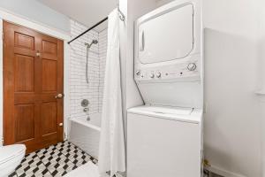 a bathroom with a toilet and a tub and a sink at Bright Coastal Escape 4 Bedroom 2 Bath Near CSULB Long Beach Airport and Beach in Long Beach +19 photos