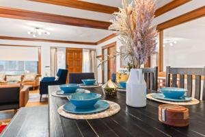 a dining room table with blue bowls on it at Bright Coastal Escape 4 Bedroom 2 Bath Near CSULB Long Beach Airport and Beach in Long Beach