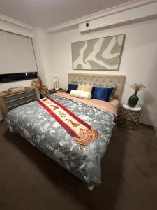 a bedroom with a large bed with a painting on the wall at Casa Blanca Haymarket in Sydney +52 photos