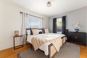 a bedroom with a bed and a window at Bright Coastal Escape 4 Bedroom 2 Bath Near CSULB Long Beach Airport and Beach in Long Beach