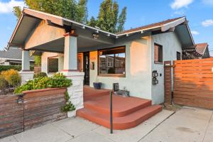 a house with a porch with a wooden fence at Bright Coastal Escape 4 Bedroom 2 Bath Near CSULB Long Beach Airport and Beach in Long Beach