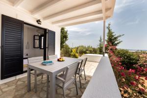 an outdoor dining area with a table and chairs on a patio at Villa Pela in Aliki