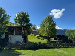 a house in a field with a fence at Ipderi cottages in Lekhtagi +20 photos