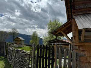 a wooden fence in front of a wooden house at Ipderi cottages in Lekhtagi