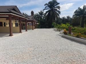 a gravel driveway in front of a house at Laman Nazira Kia in Kampong Ijok