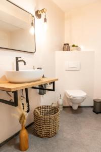 a bathroom with a sink and a toilet at Ferienwohnung Alpenglück in Seeg +15 photos