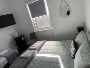a bedroom with a bed and a window at Royal Mail Hotel Mulwala in Mulwala