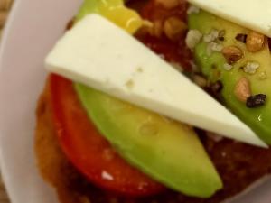 a close up of a sandwich with cheese and vegetables at Salicornia Doble in Amposta