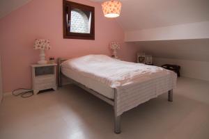 a bedroom with a bed and a table and a window at Brigidahoeve in Maastricht