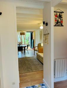 a hallway leading to a living room with a couch at Maison cap ferret proche des plages in Lège-Cap-Ferret