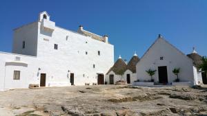 a large white building with a bunch of windows at Masseria Mangiato 1557 in Alberobello +28 photos