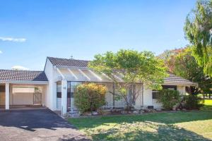 a large white house with a garage at Jetty Views -100m to foreshore in Busselton