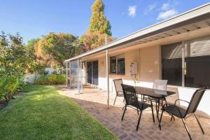 a patio with a table and chairs in a yard at Jetty Views -100m to foreshore in Busselton +2 photos