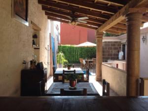 an outdoor patio with a table and a ceiling fan at Suites colibri in San Miguel de Allende