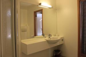 a bathroom with a sink and a mirror at Mitt hotell & apartments in Moss