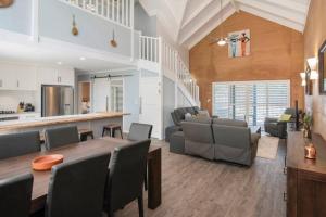 a dining room and living room with a table and chairs at Sea Breeze Villa in Dunsborough